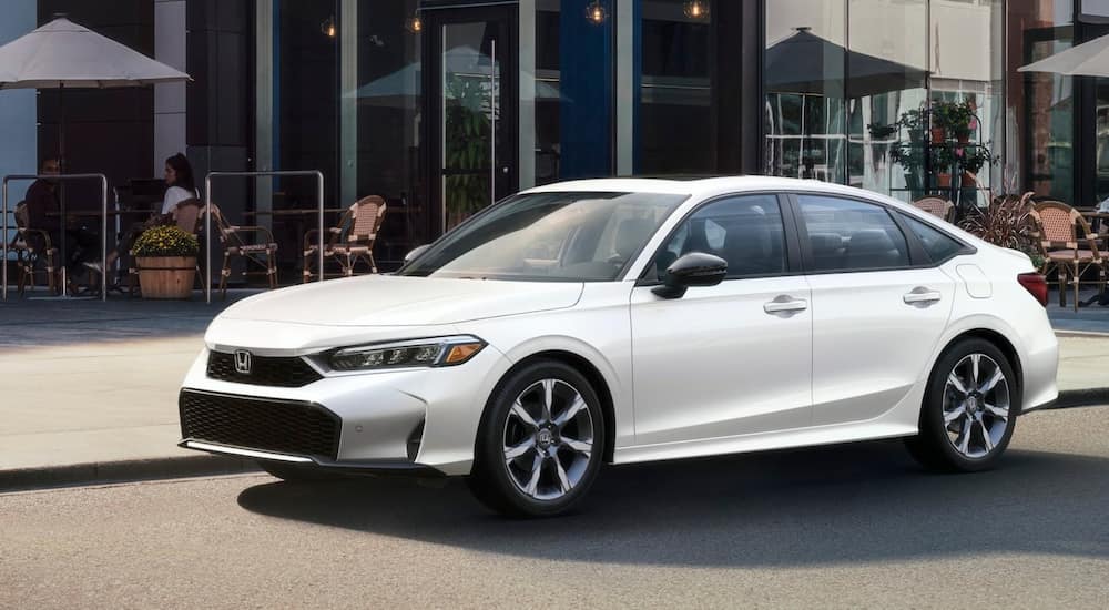 Side of a white 2026 Honda Civic parked by a curb.