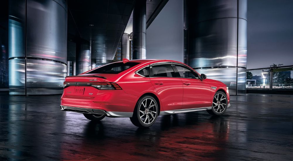 A red 2025 Honda Accord parked at night