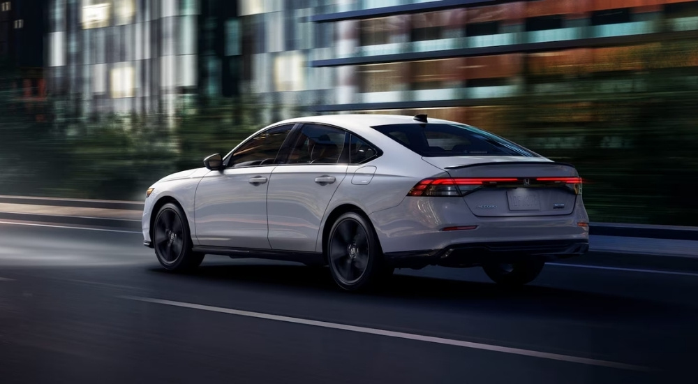 A white 2025 Honda Accord driving in a city