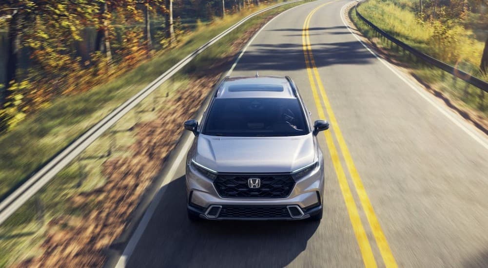 A silver 2026 Honda CR-V driving on a highway.