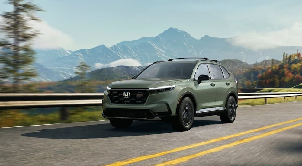 A green 2026 Honda CR-V driving to a Honda dealer near Birmingham.