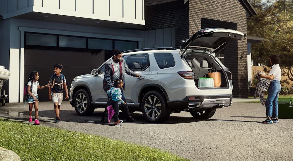 A white 2026 Honda Pilot parked on a driveway.