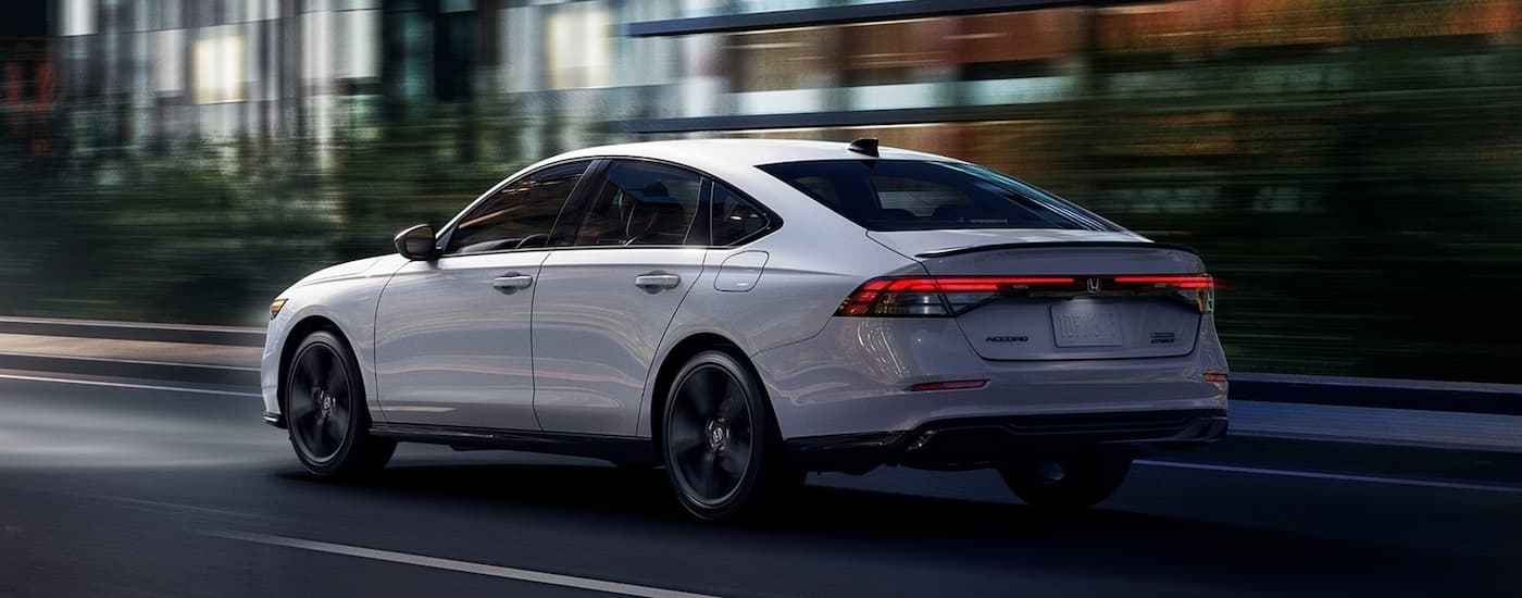 A white 2026 Honda Accord driving in a city