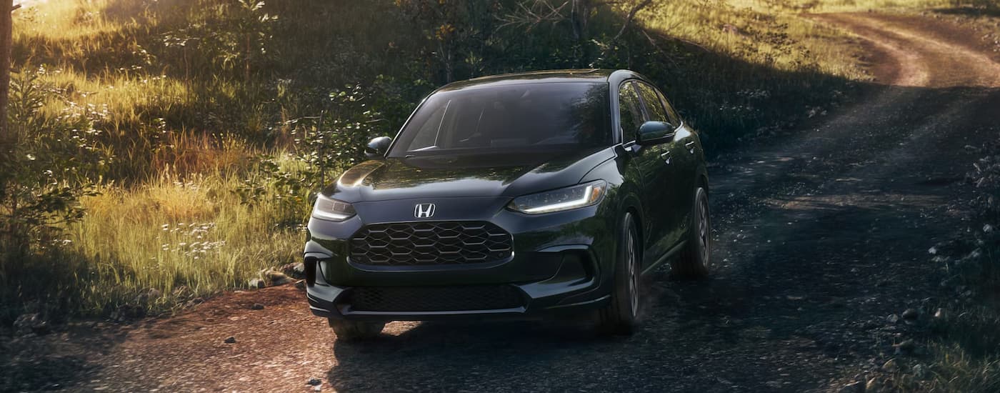 Black 2026 Honda HR-V driving on a dirt road