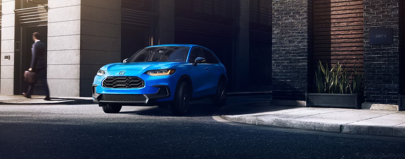 Blue 2026 Honda HR-V driving on a city street