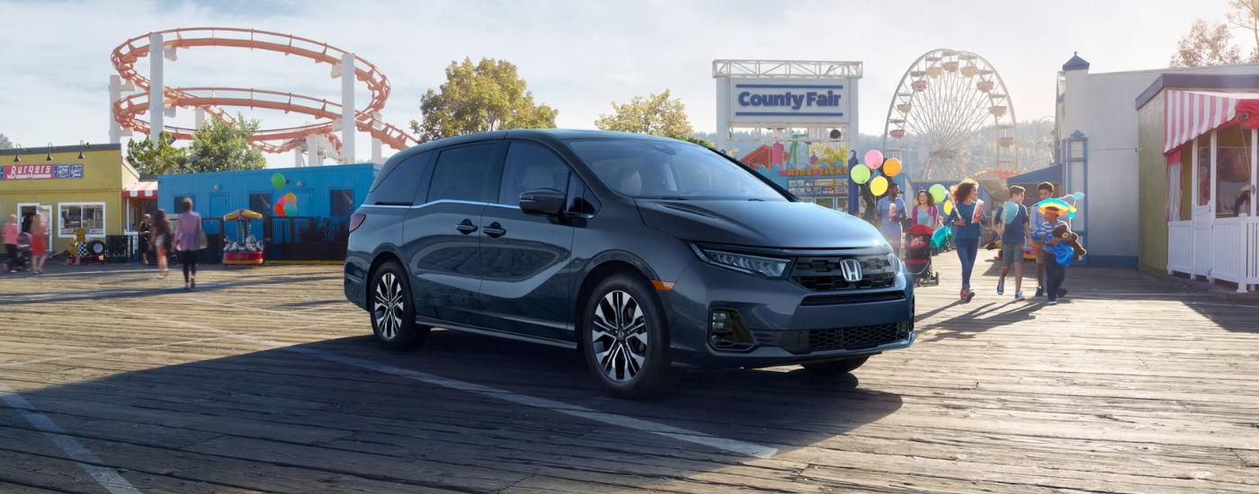 Grey 2026 Honda Odyssey parked in front of a fair