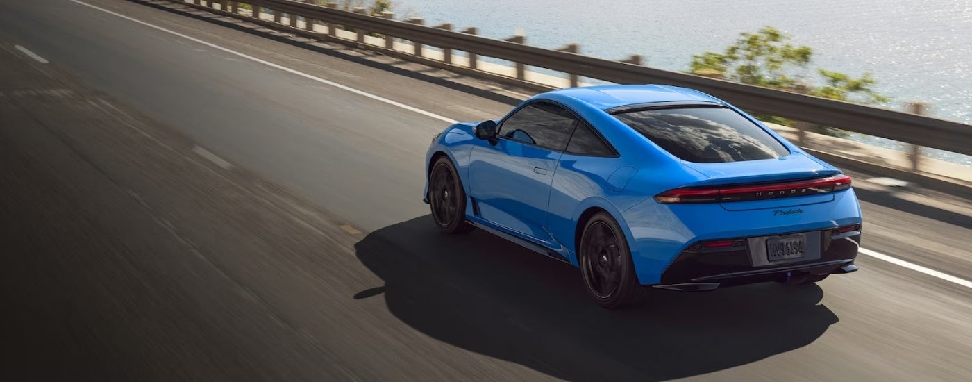Blue 2026 Honda Prelude driving on a highway