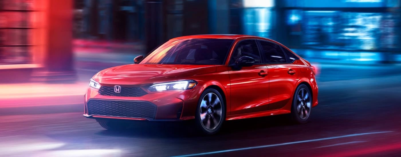 A red 2025 Honda Civic from the front at an angle.