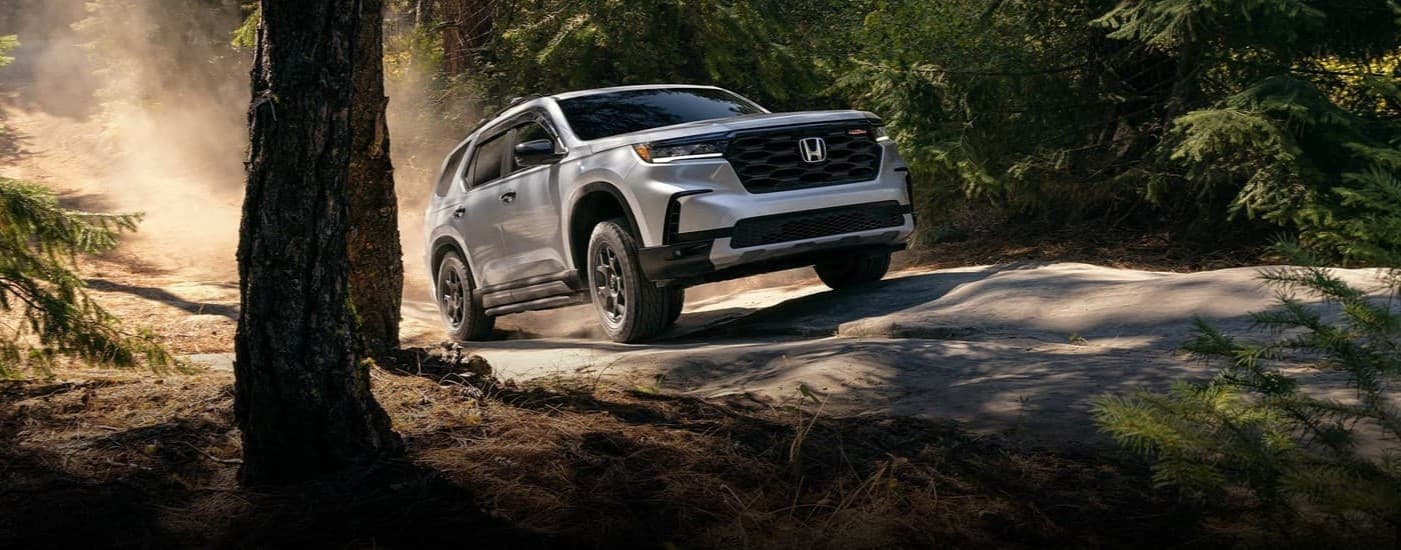 A gray 2025 Honda Pilot Trailsport off-roading.