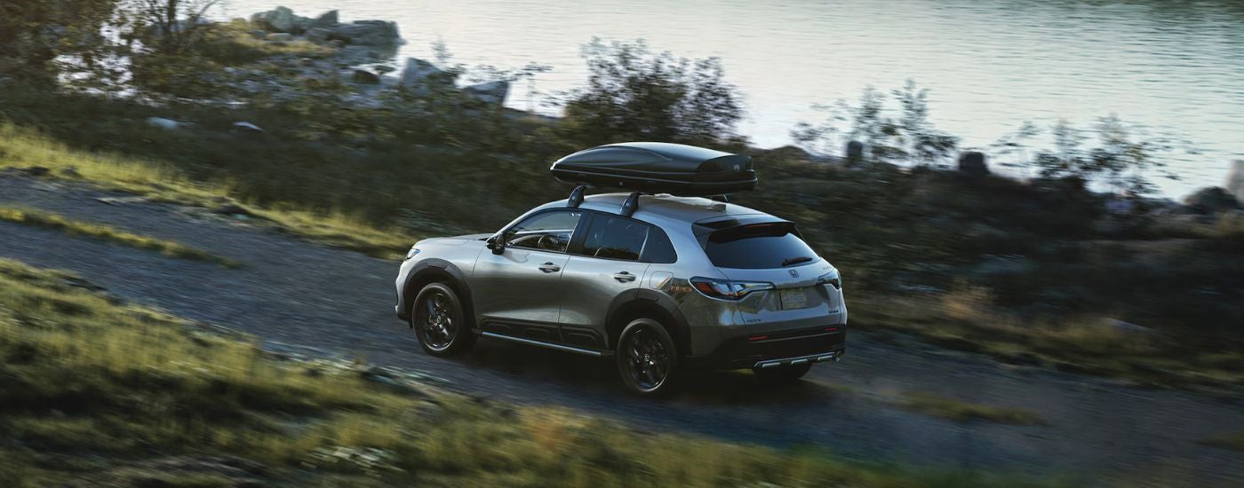 A silver 2025 Honda HR-V HPD Edition driving off-road.